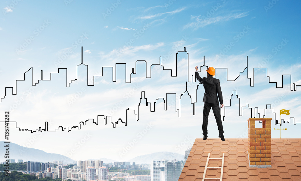 Man architect draw silhouette of modern city on blue sky. Mixed media Man architect draw silhouette of modern city on blue sky. Mixed media