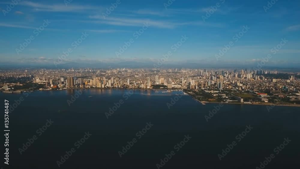 Aerial view skyline of Manila city at sunset. Fly over city with skyscrapers and buildings. Aerial skyline of Manila . Modern city by sea, highway, cars, skyscrapers, shopping malls. Aerial footage Aerial view skyline of Manila city at sunset. Fly over city with skyscrapers and buildings. Aerial skyline of Manila . Modern city by sea, highway, cars, skyscrapers, shopping malls. Aerial footage