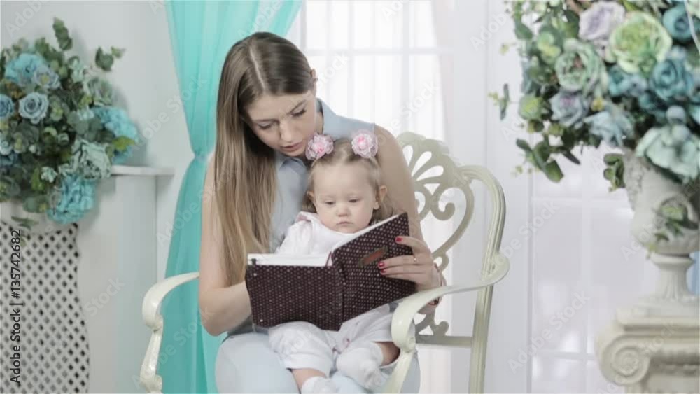 Mother And Daughter Reading A Book Together Mother And Daughter Reading A Book Together