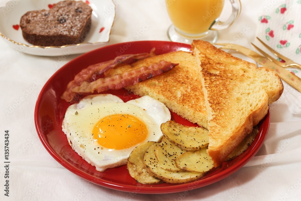 Valentine breakfast with heart shaped egg bacon bread toast cup of coffee served in red plate Valentine breakfast with heart shaped egg bacon bread toast cup of coffee served in red plate