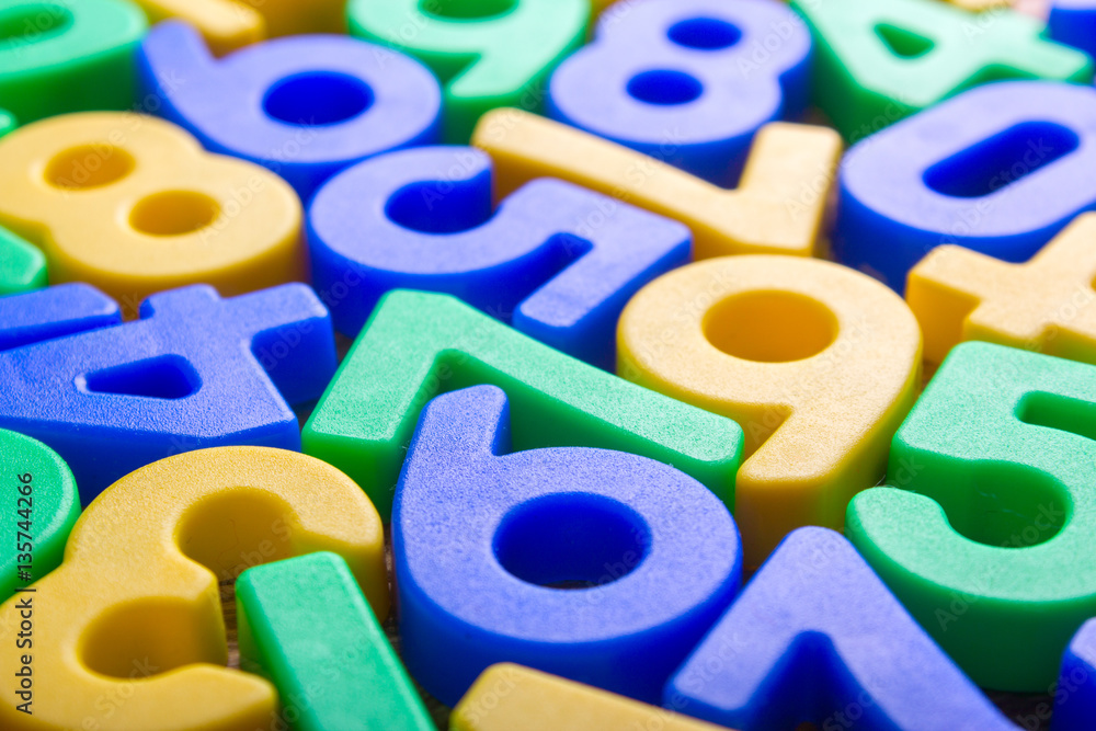 Fototapeta premium Colored numbers scattered on the wooden table