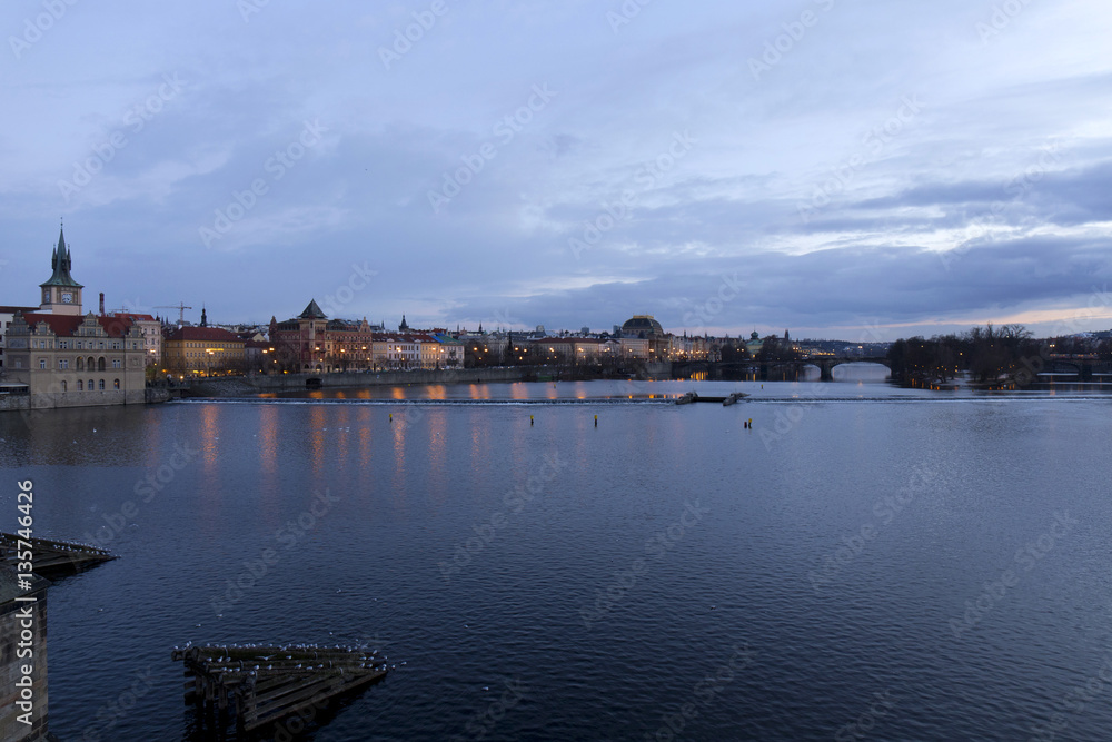 Evening Prague City above River Vltava after sunset from Charles Bridge, Czech Republic