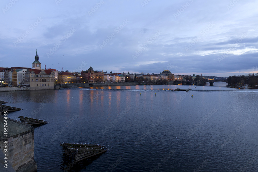 Evening Prague City above River Vltava after sunset from Charles Bridge, Czech Republic