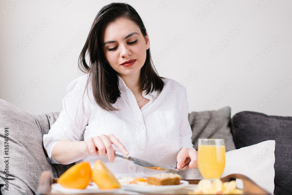 Young woman starting her day with a healthy breakfast Young woman starting her day with a healthy breakfast