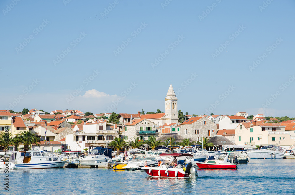 Summer view of Pakostane harbor waterfront in Dalmatia, Croatia.