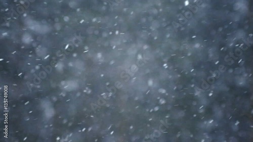 Background of snow fall blowing fast in winter blizzard.