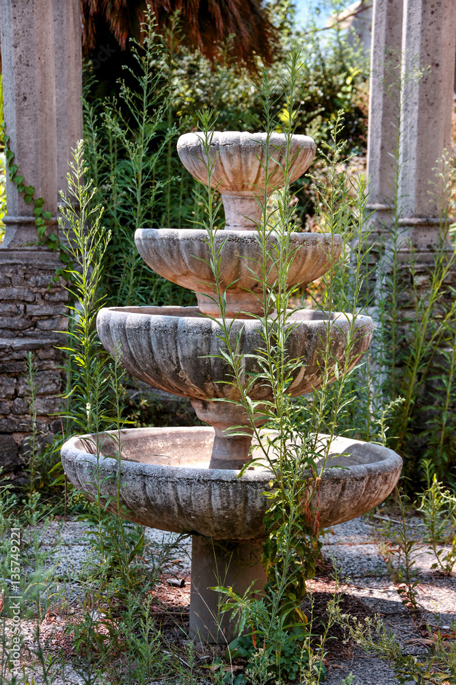 Old stone decorative fountain in the abandoned garden Old stone decorative fountain in the abandoned garden