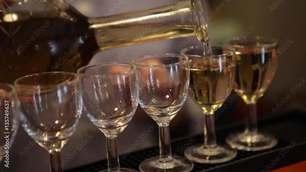 pouring a strong drink to liqueur glasses pouring a strong drink to liqueur glasses