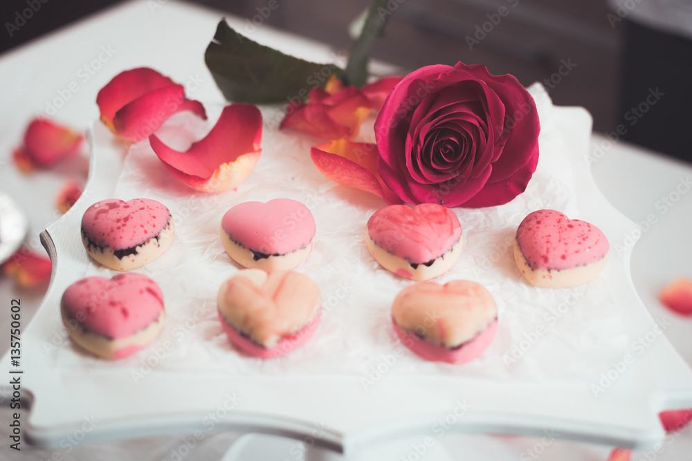 Candies in the form of hearts with rose petals around Candies in the form of hearts with rose petals around