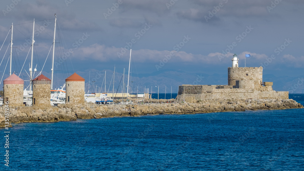 Windmills and lighthouse on Rhodes island in Greece