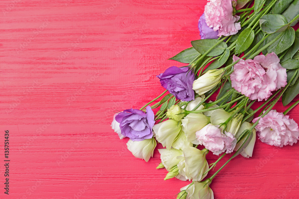Bouquet of eustoma flowers on red wooden background
