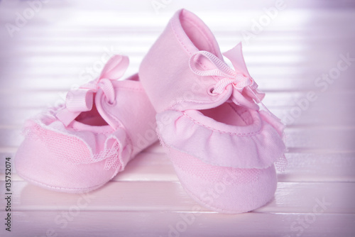 New children shoes on wooden background