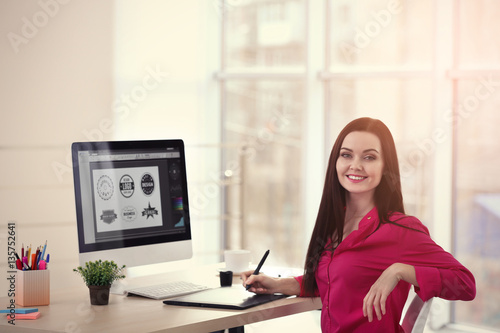 Young female designer worki...