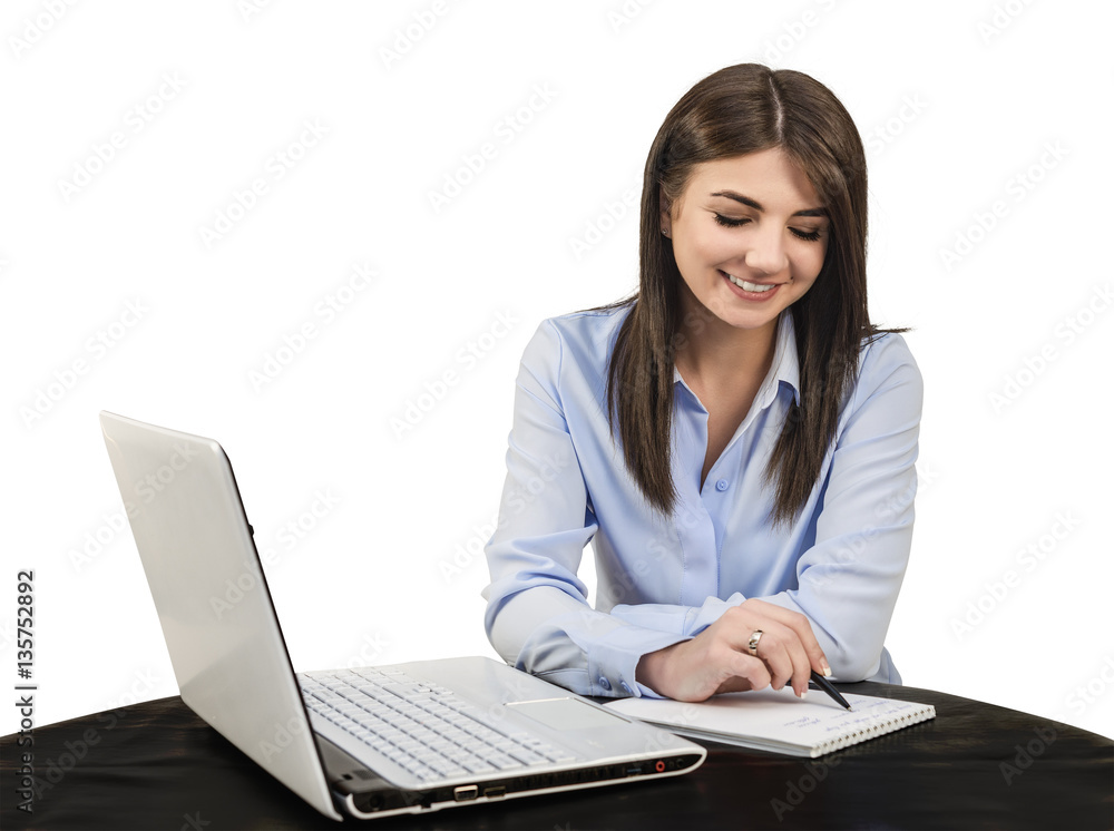 Cheerful young girl is writing in a notebook. White isolated background. Cheerful young girl is writing in a notebook. White isolated background.