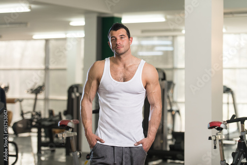 Man In Undershirt Flexing Muscles