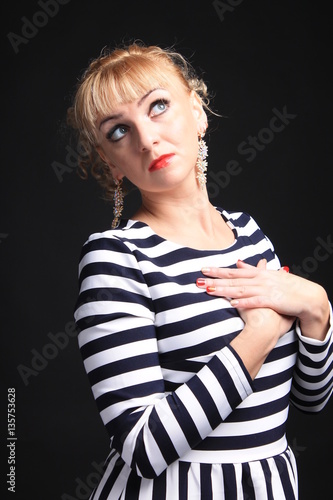blonde in a striped dress on a black background