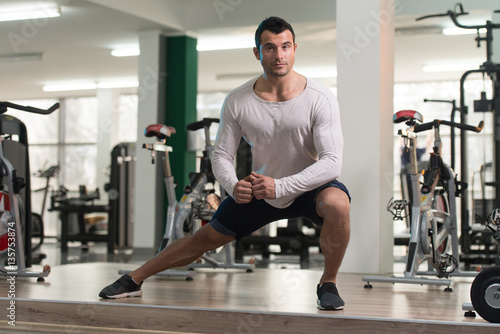 Healthy Man Stretches At The Floor