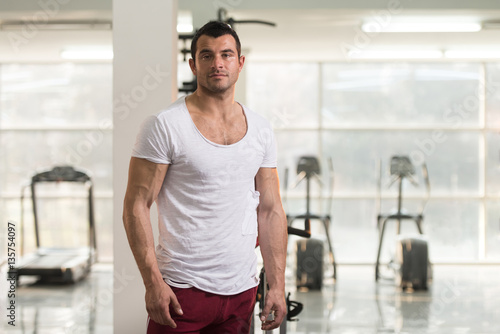 Strong Man in White T-shirt Background Gym