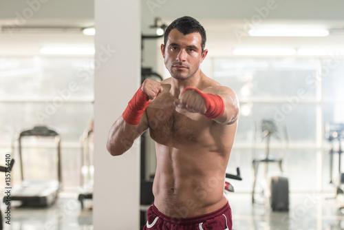 Handsome Man With Red Boxing Gloves In Gym