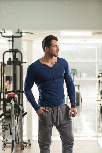 Strong Man in Blue T-shirt Background Gym