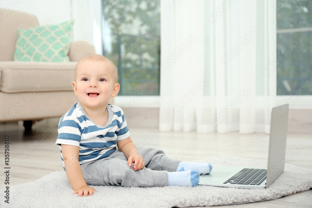 Cute baby boy with laptop on carpet Cute baby boy with laptop on carpet