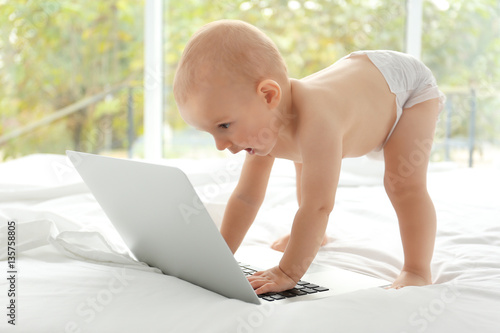 Cute baby boy with laptop o...