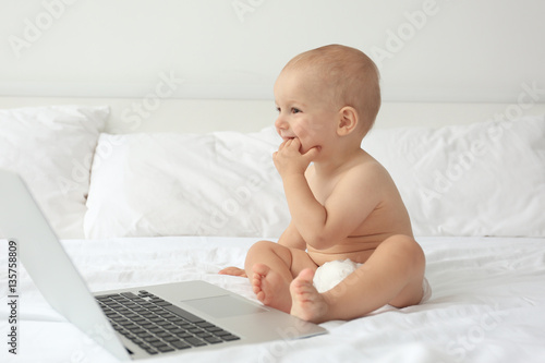 Cute baby boy with laptop o...