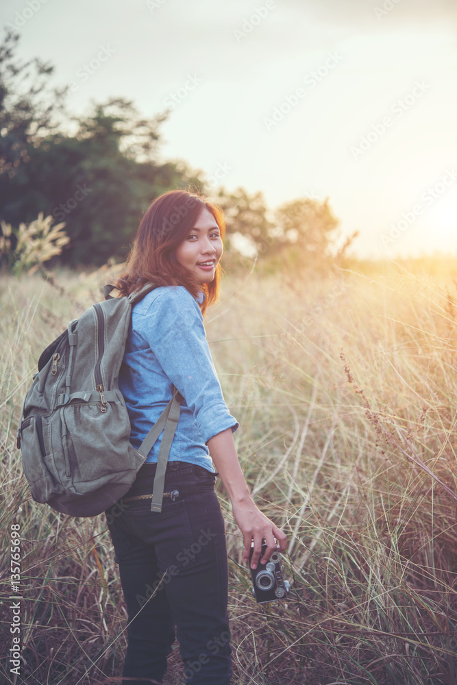 Vintage tone images of beautiful young hipster woman with backpack.