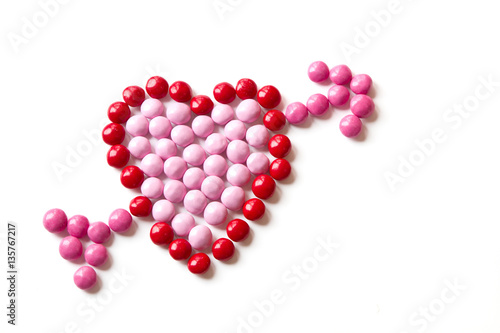 Red and Pink Coated Candy shaped in a heart isolated on white ba