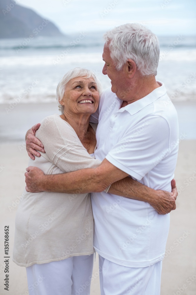 Senior couple embracing each other on the beach Senior couple embracing each other on the beach