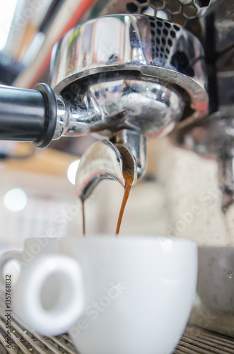 Barista making a cup of coffee soft focus image .