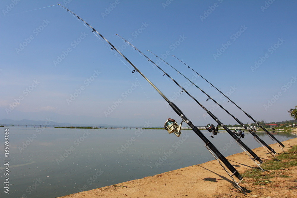 Fishing-rod at the lake under blue sky