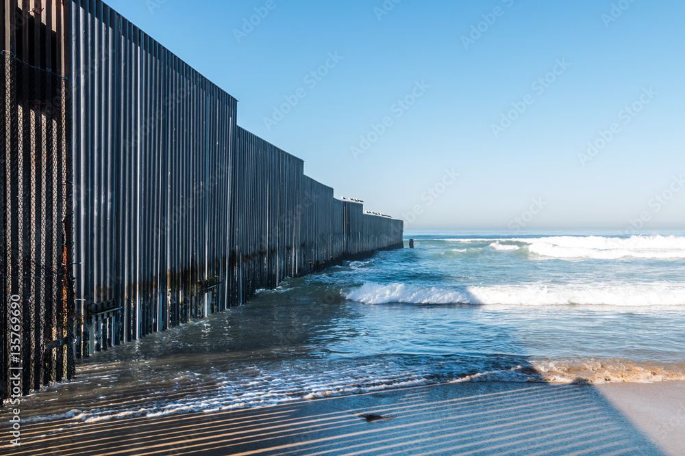 Border Field State Park beach in San Diego, California with the international border wall