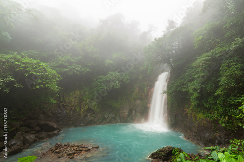 Rio celeste waterfall at foggy day