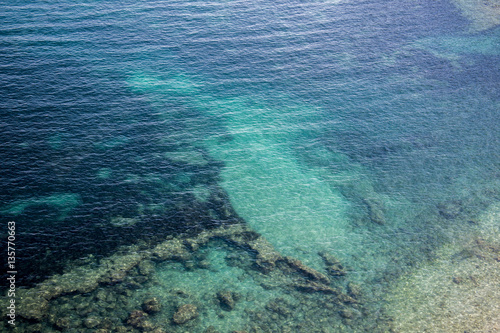 Turquoise sea with rocky bottom