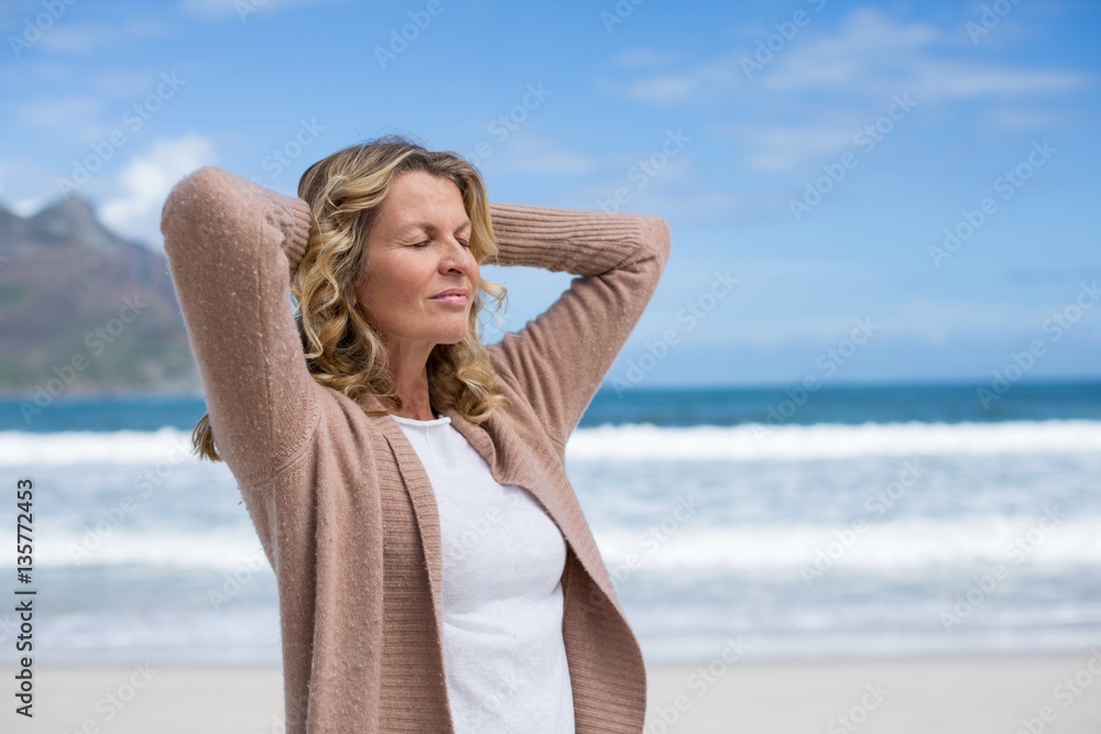 Mature woman with hands behind head and eyes closed Mature woman with hands behind head and eyes closed
