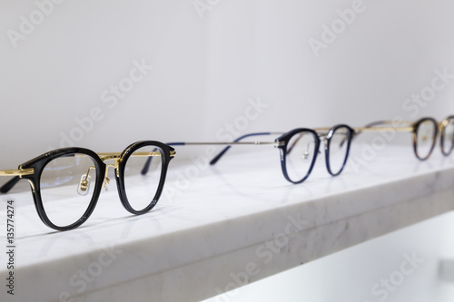 detail view of various eyeglasses lying on a tray.