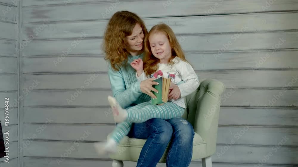 Girl with mother read the book Girl with mother read the book