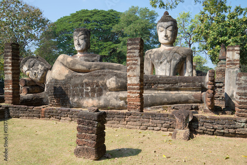Three ancient sculptures of Buddha in ruins of Wat Phra Kaew. Kamphaeng Phet, Thailand