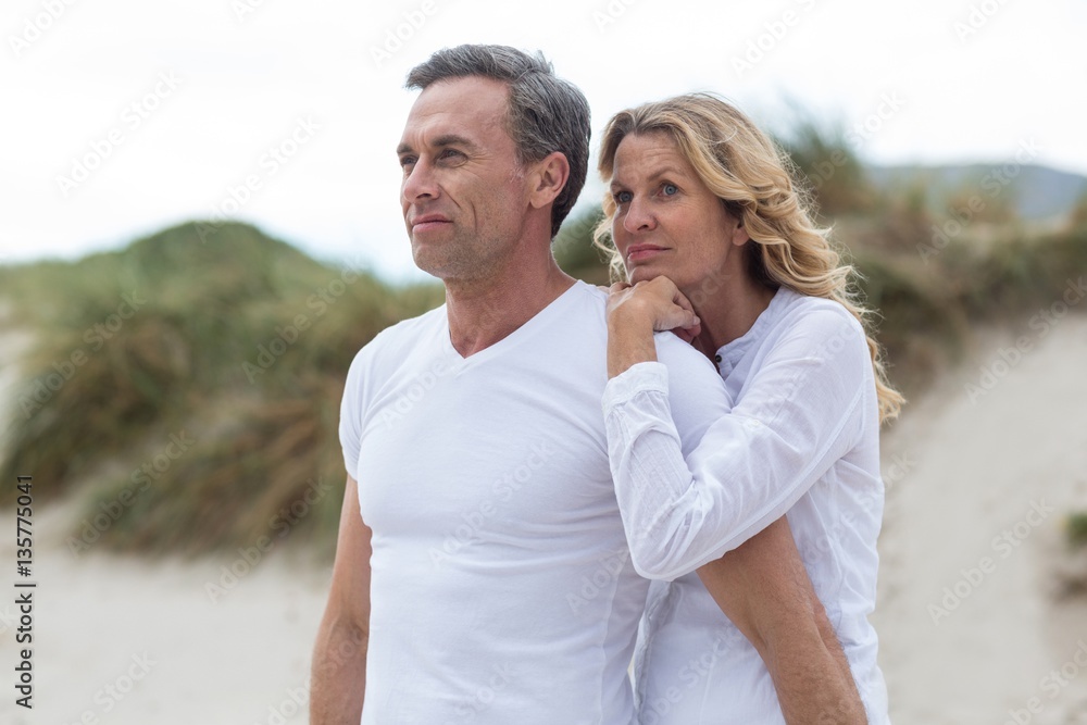 Mature couple standing together on the beach Mature couple standing together on the beach