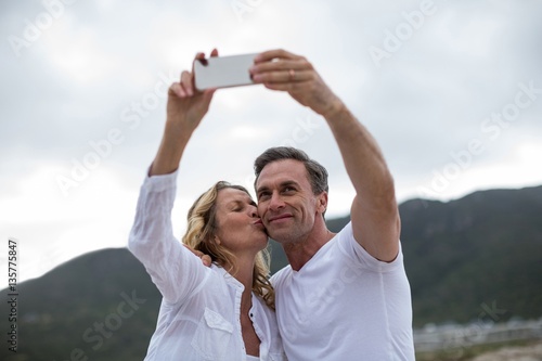 Mature couple taking selfie using mobile phone