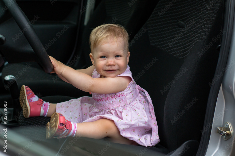 Small cute baby in a car in a warm day Small cute baby in a car in a warm day