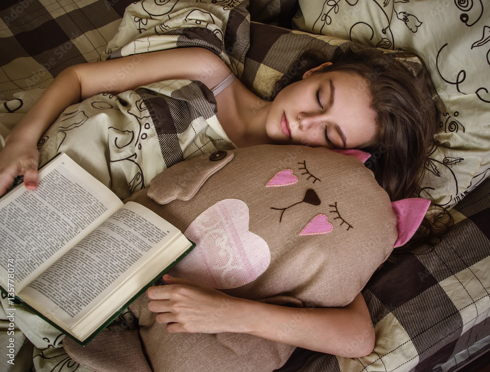 beautiful white Caucasian girl with long hair sleeping on bed in