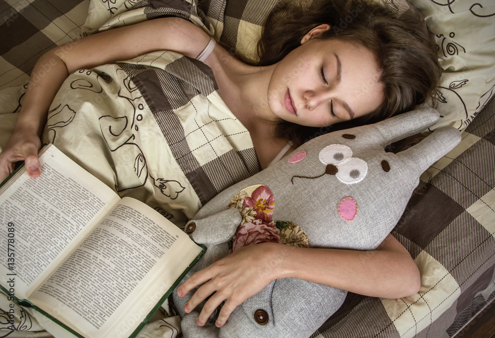 beautiful white Caucasian girl sleeping on bed in her bedroom wi
