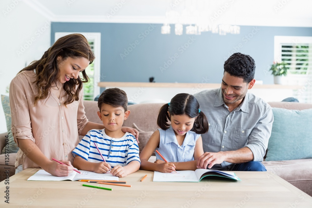 Parents assisting their kids in doing homework Parents assisting their kids in doing homework