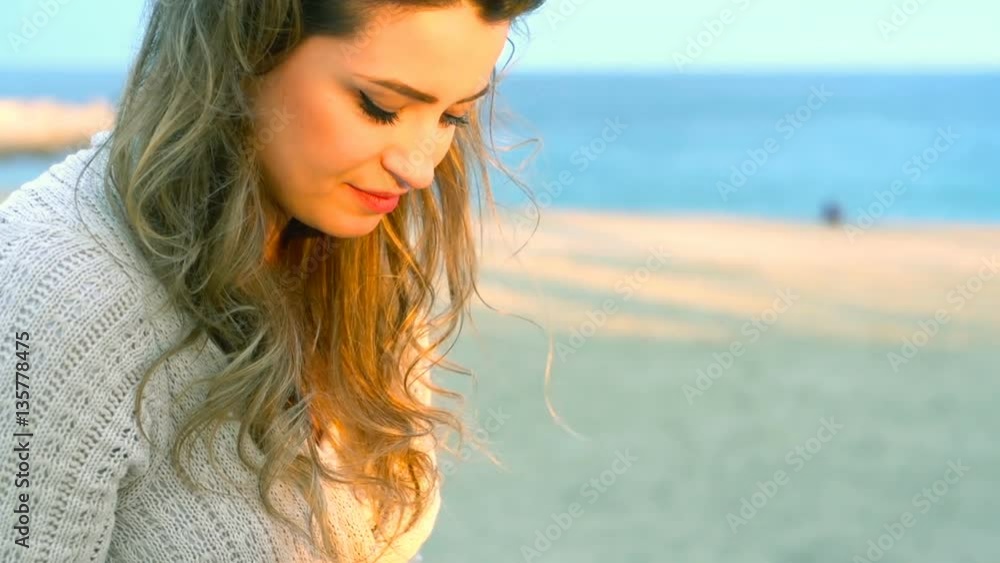 Happy woman sitting at the sea and using smartphone, steadycam shot
Happy woman sitting at the sea and using smartphone, steadycam shot