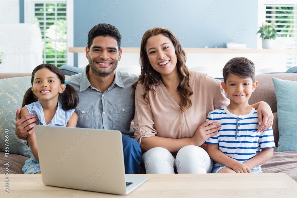 happy parents and kids sitting with arm around happy parents and kids sitting with arm around