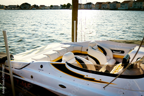Slika na platnu Small white speed boat docked with leather seat