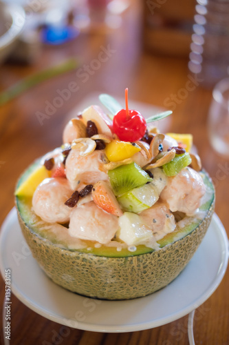 Healthy fruit salad with yogurt in cantaloupe bowl