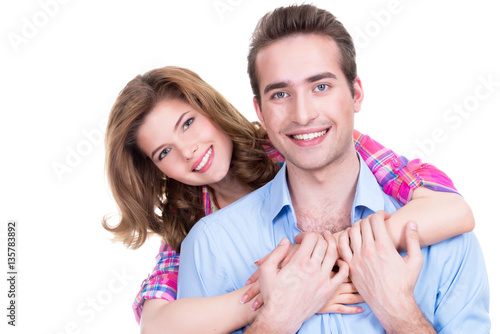 Young attractive couple standing in studio.